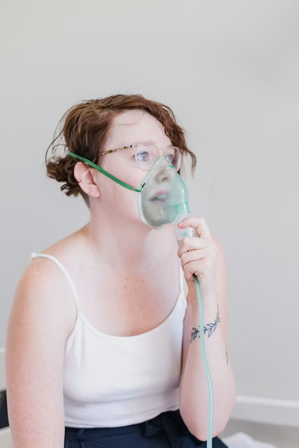 essential home medical devices. Woman wearing a nebulizer